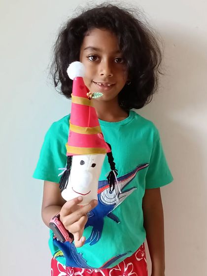 A wonderfully unique Santa Gnome with braided hair, showcasing the individual creativity of each student.