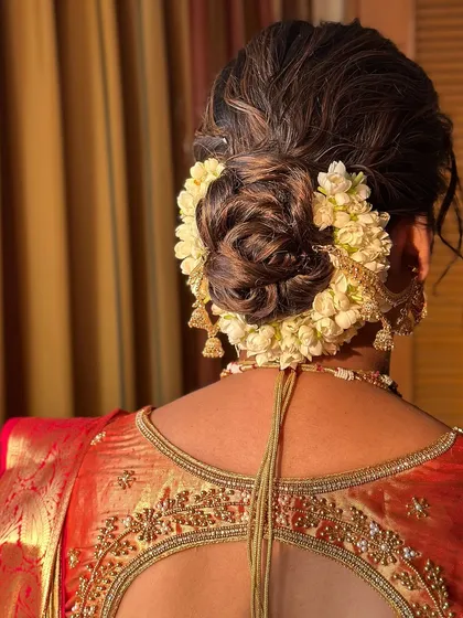 A view of the traditional South Indian bridal bun, beautifully adorned with fresh jasmine flowers (gajra).
