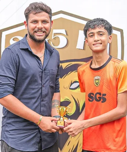 A young player's hard work is rewarded with a Player of the Match trophy during the Inter SG5 Cup.