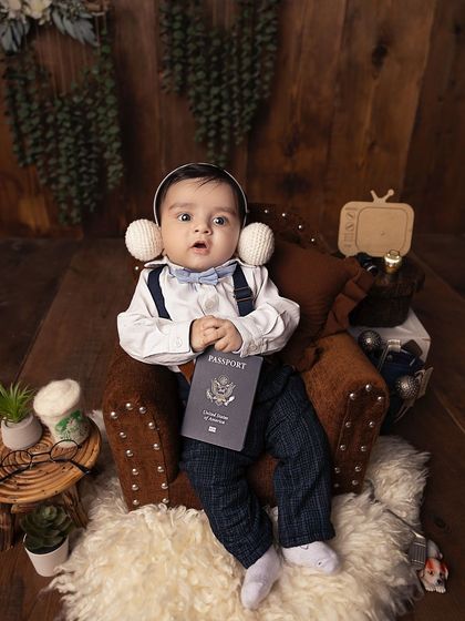 This little guy is ready for his journey, passport in hand. Sitter sessions are a great time to introduce playful themes and props as babies can interact with them.
