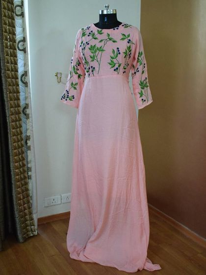 This soft pink gown is all about subtle elegance. I designed it with delicate green and black floral embroidery climbing up the sleeves and bodice, creating a soft, romantic look perfect for a daytime wedding or engagement party.