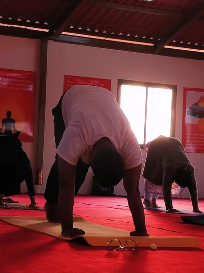 Participants in our Ahmednagar workshop practicing a downward-facing posture. The commitment and spirit of every participant, including an Army colonel who traveled from Ladakh, was truly inspiring.