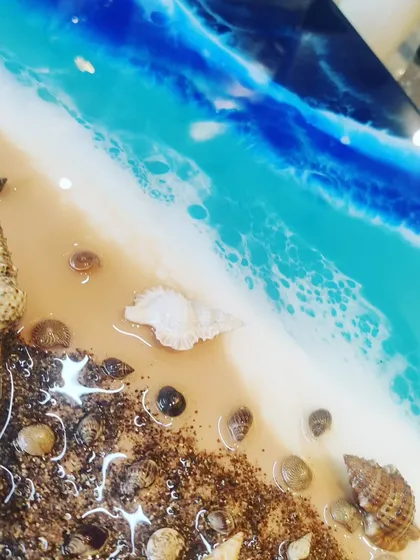 Who doesn't love the beach? In my ocean theme workshop, you will learn how to create realistic sea effects using resin, sand, and real shells. It's like capturing a piece of the ocean forever.