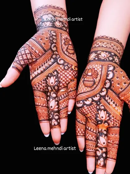 This guest design features auspicious elements like a kalash and lotus flowers. The mix of bold and fine lines gives it a rich, textured appearance.