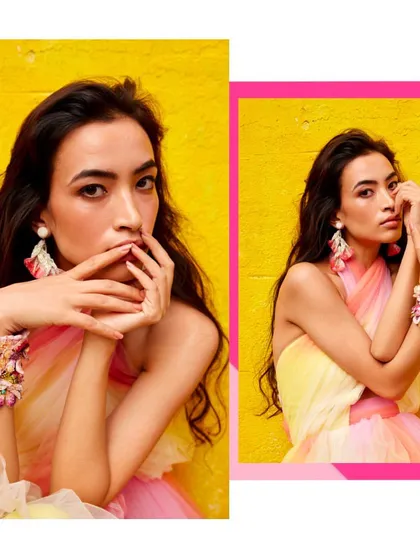 A bright and cheerful look from the campaign, set against a vibrant yellow wall. The styling here is playful, with a gradient tulle dress and floral accessories that feel fresh and summery.