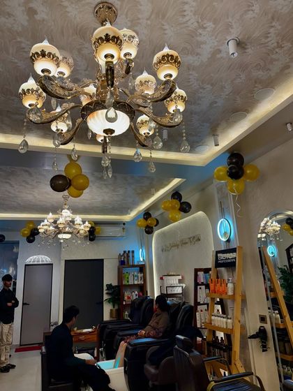 The elegant and luxurious ambiance of our salon, complete with beautiful chandeliers and comfortable seating.