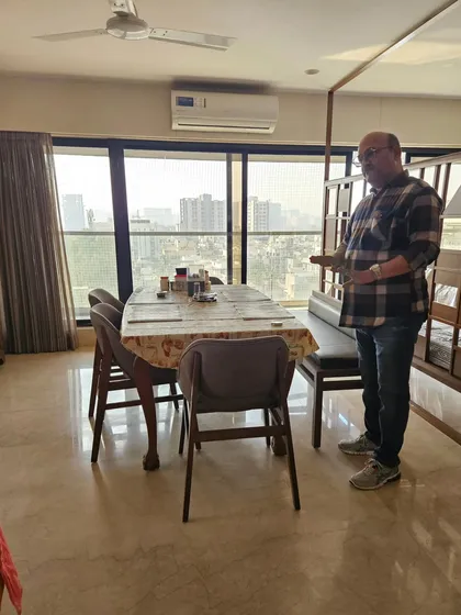 Assessing the dining area of a home. The placement of the dining table affects family bonding and health, so it's an important part of my consultation.