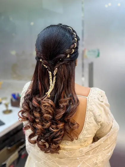 A romantic and delicate hairstyle with intertwined braids and a subtle, sparkling accessory.
