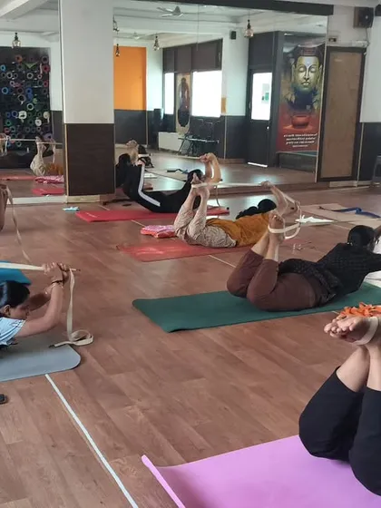 Props are tools for empowerment. Here, my students are using yoga straps in Dhanurasana, the Bow Pose, to get a better lift and a deeper backbend. This technique helps open the shoulders and chest while protecting the lower back.
