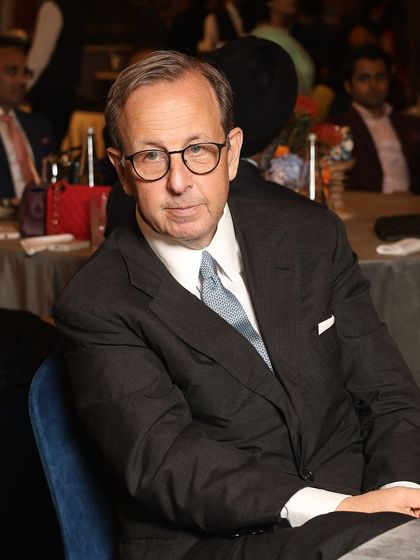 An esteemed guest at our exclusive gathering with Ermenegildo Zegna. His classic charcoal suit, tailored to perfection, epitomizes the understated elegance that is a hallmark of our work.