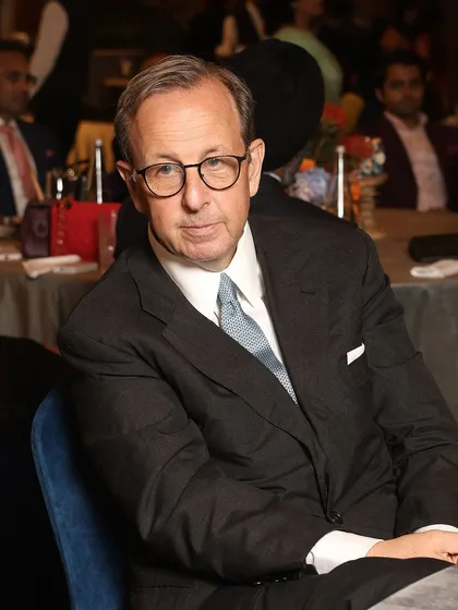 An esteemed guest at our exclusive gathering with Ermenegildo Zegna. His classic charcoal suit, tailored to perfection, epitomizes the understated elegance that is a hallmark of our work.