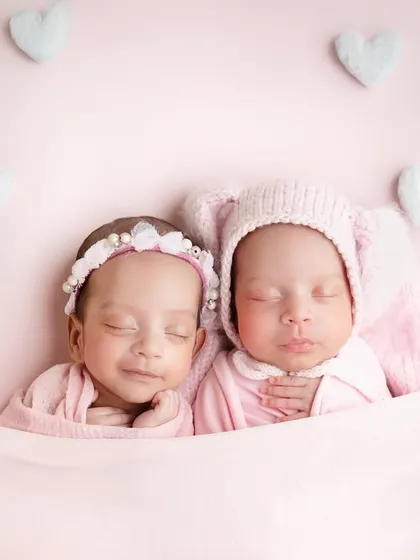 To the most adorable duo. Tucked in together under a soft pink blanket, these twin girls look so peaceful and content.