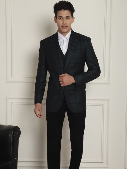 A full view of the dark green plaid suit. We have suits for every need, from office wear to weddings.