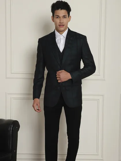 A full view of the dark green plaid suit. We have suits for every need, from office wear to weddings.