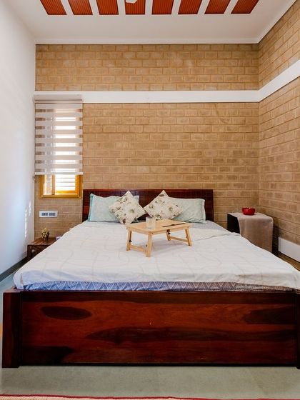 A view of the bed and bay window in the master bedroom.