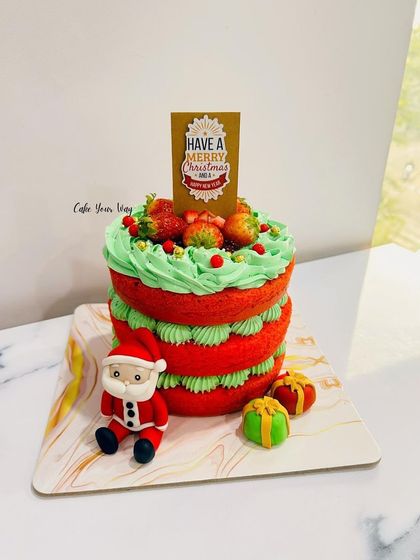 Christmas delights. A festive red and green naked cake with a little fondant Santa.