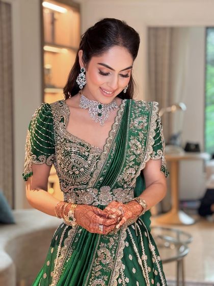 A candid moment of the bride during her puja ceremony. Her makeup is flawless, and her smile is radiant.
