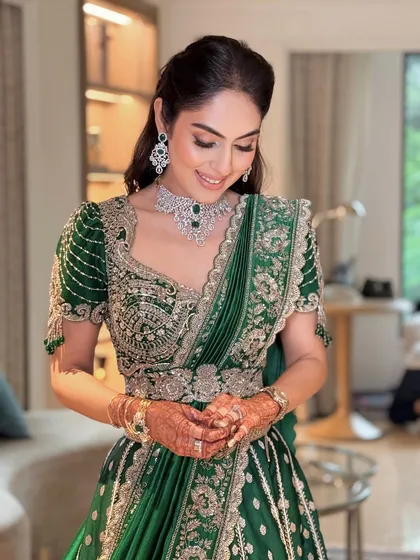 A candid moment of the bride during her puja ceremony. Her makeup is flawless, and her smile is radiant.