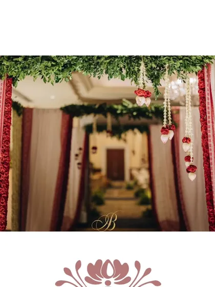 To honor the couple's heritage, we designed this elegant entrance for a Bengali reception using traditional Bengal cotton Tant sarees. The iconic red and white fabric, paired with fresh greenery, created a culturally rich and beautiful passageway for the celebration.