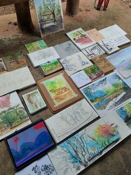 Another view of the beautiful sketchbooks created during our group session at the park. You can see a variety of styles and mediums, from watercolor paintings to ink drawings, all inspired by the surrounding nature.