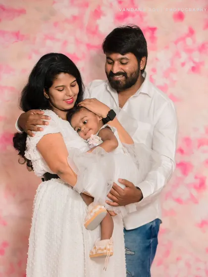 A classic studio family portrait against a soft pink backdrop. In-studio sessions are great for timeless photos with perfect lighting, especially for families with young children.