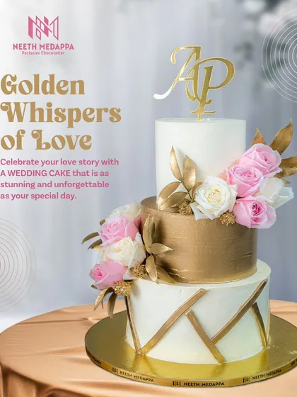 This three-tier wedding cake is a study in modern luxury, blending clean lines with opulent details. It features a striking brushed gold middle tier, geometric gold accents, and is softened by clusters of fresh pink and white roses, all personalized with the couple's monogram.