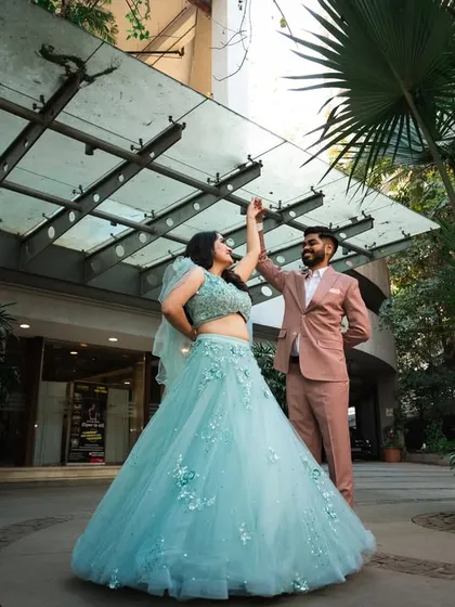 A playful and dynamic shot of the couple dancing. This wide-angle view captures their energy and the architecture of the location.