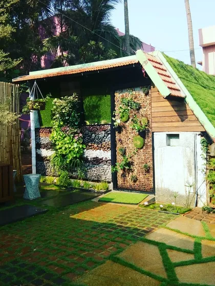 I love projects that let me get creative. Here, I designed and built a complete garden structure, featuring a living green roof, a mixed-material wall with stone and plants, and custom vertical planters.