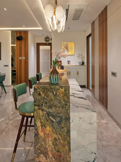 The beauty of our work is often in the details. This custom bar counter features a striking combination of two distinct marbles, showcasing our ability to play with rare materials and create unique focal points within a home.