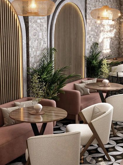 This view shows the comfortable pink banquette seating against a wall with wood paneling and arched details. The mix of textures creates a warm and inviting atmosphere.