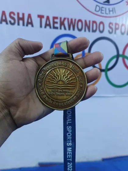 A close-up of the gold medal won at the Kendriya Vidyalaya Sangathan Regional Sports Meet. A symbol of hard work and achievement.