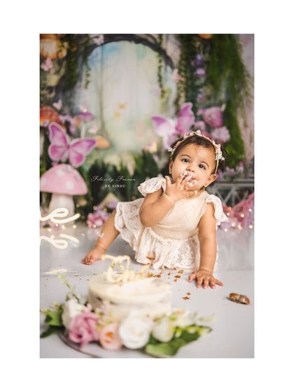 A fairy enjoying her first taste of birthday cake. The enchanted forest backdrop makes this cake smash session truly magical.