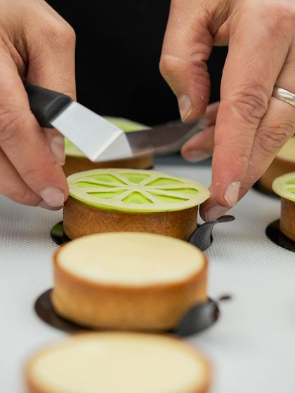 Precision in action. Chef Antonio Bachour demonstrates how to place a delicate lime-flavored decoration on a mini tart.