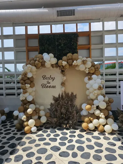 This is our rustic and elegant "Baby in Bloom" baby shower theme. We used a neutral color palette with brown, beige, and white balloons, complemented by dried pampas grass for a soft, natural look.