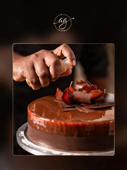 The final touch. A chef adds a delicate chocolate flower to one of our signature cakes, showcasing the artistry that goes into every dessert we create.