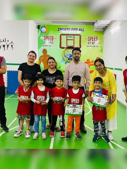 A group photo with all the kids and parents celebrating the 'Most Valuable Kid' awards.