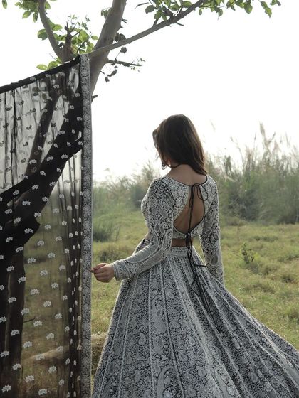 A dramatic shot of this stunning black and white embroidered lehenga, with its beautiful backless design.