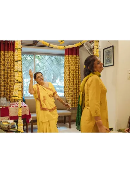 The festivities begin! A candid shot of family members dancing and enjoying the start of the Mehendi ceremony.