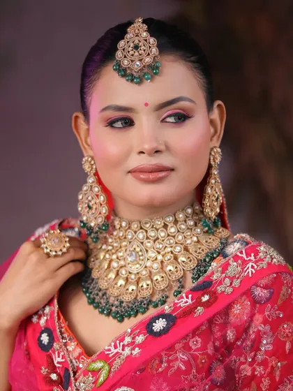 From learners to artists. Our students master the art of bridal makeup, creating breathtaking looks like this one with a vibrant pink lehenga and heavy kundan jewelry.