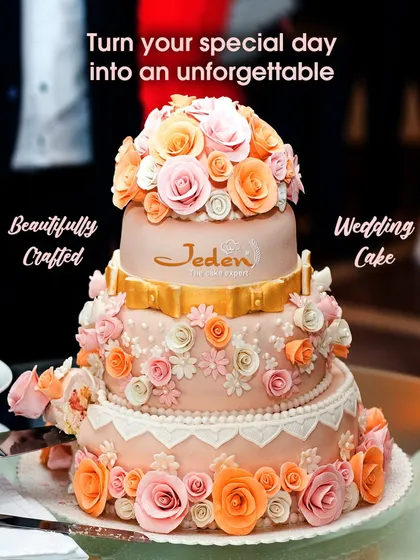 A masterpiece for a milestone moment. This three-tiered wedding cake features delicate peach and pink sugar flowers cascading down its elegant form, finished with a touch of gold for a truly luxurious statement.