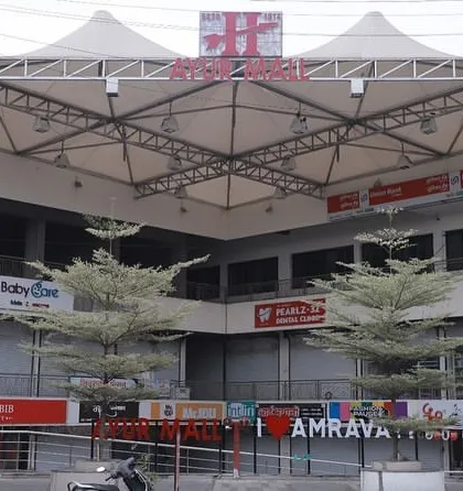 A closer look at the entrance and facade of Ayur Mall. The design strategically uses landscaping and open frontage to create a seamless transition from the street to the commercial spaces within, enhancing the building's accessibility.