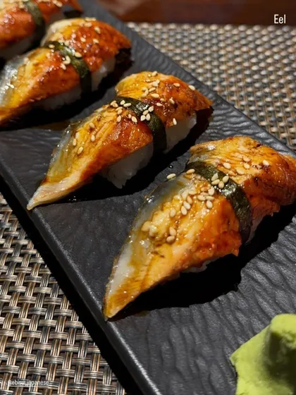 Our Unagi Nigiri features grilled freshwater eel glazed with a sweet and savory sauce, then sprinkled with sesame seeds. This traditional dish offers a rich, smoky flavor that is both comforting and delicious.