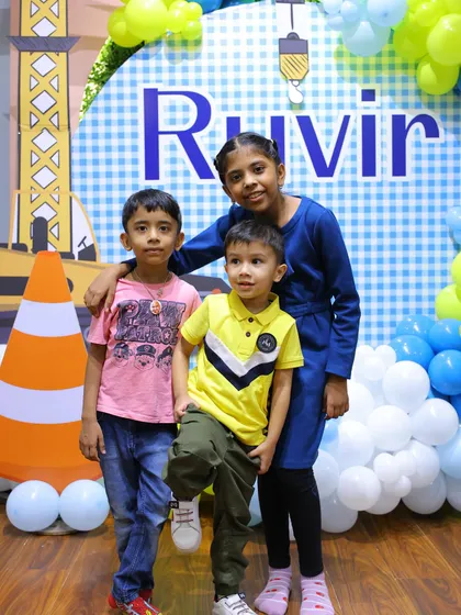 The birthday boy and his friends pose for a group photo, showing off their cool party style.