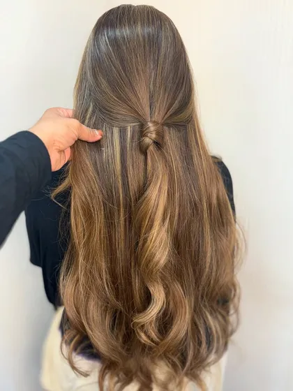 A closer look at the half knot style on this blonde balayage, showing the intricate blend of colors.