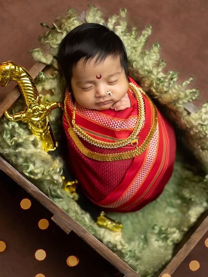 A top-down perspective of the baby in the crate, giving a full view of the setup and the beautiful contrast of colors and textures.