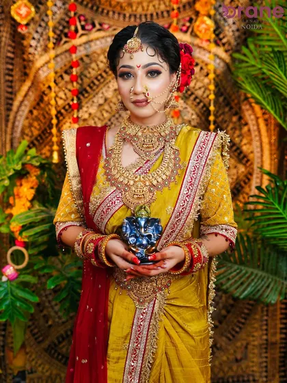 A full-frontal shot capturing the complete festive look, from the traditional bindi and nath to the heavy gold jewelry.