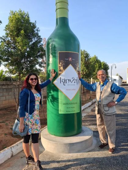 Posing with a giant wine bottle at Kinvah Wines. I am always ready to host your next cocktail party or sophisticated gathering.