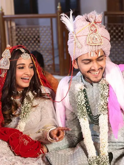 A candid moment of laughter during the pheras. This bride chose a beautiful white and silver lehenga, and we complemented it with a soft, natural makeup look.