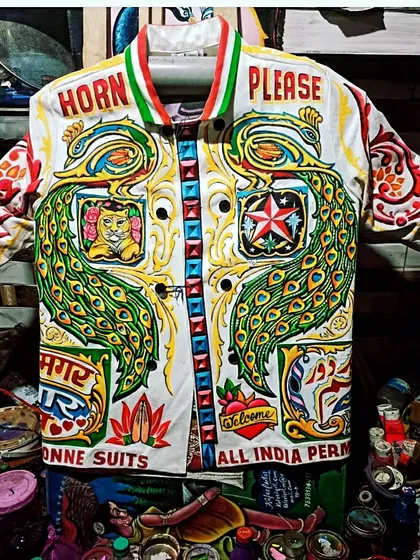 A true celebration of Indian truck art on a jacket. This piece is packed with iconic elements like the 'Horn Please' slogan, majestic peacocks, and multi-lingual text, all hand-painted in dazzling colors. It’s a wearable piece of desi pop culture.