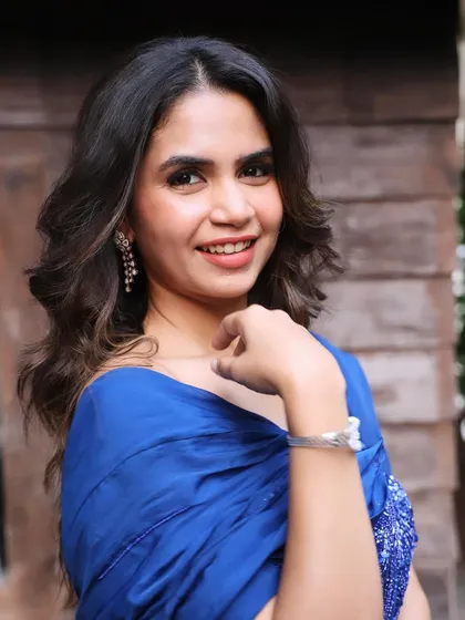 A beautiful, happy shot showing the complete look. The soft waves and glowing makeup are perfect for any celebration.